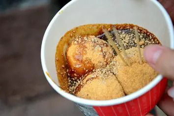 Sugar-oil balls: fried, sesame-rolled and skewered