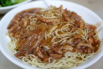 A bowl of lo mein, every strand coated in sauce