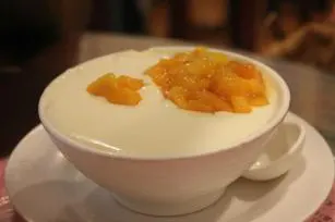 Double-skin milk pudding under fresh mango