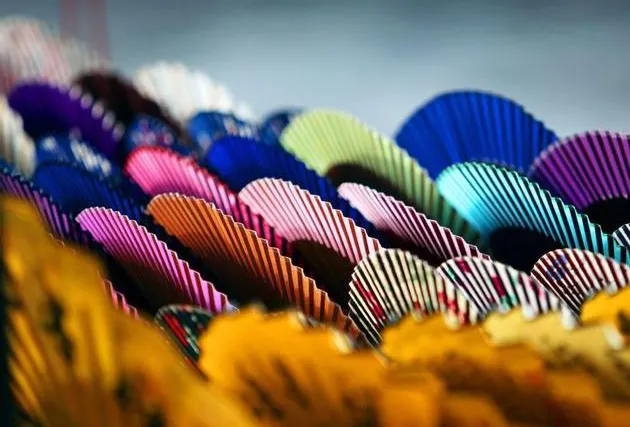 Painted folding fans laid out on a stall