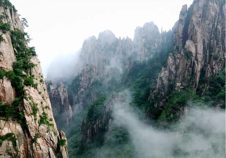 A ravine in the West Sea: cloud rising from the floor and cutting the peaks into layers