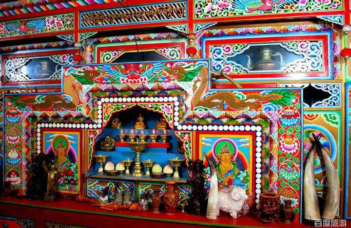 A temple front painted red, gold and blue — Tibetan decoration at its densest