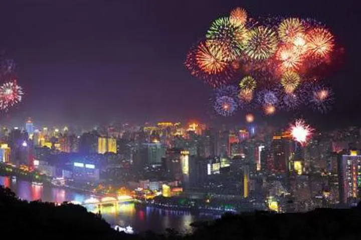 The Yellow River banks after dark, with fireworks opening above the city