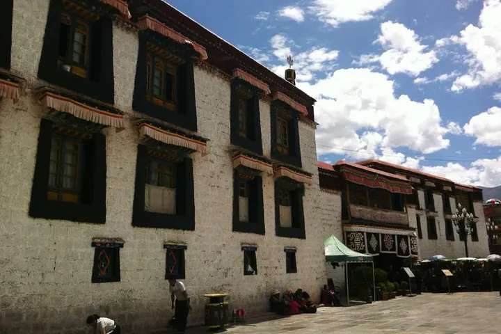 Whitewash, black window surrounds, pleated valances above each window: the standard monastery facade