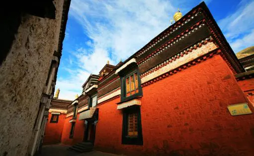 Red wall, white band, gilded finial: monastery walls keep to three colours