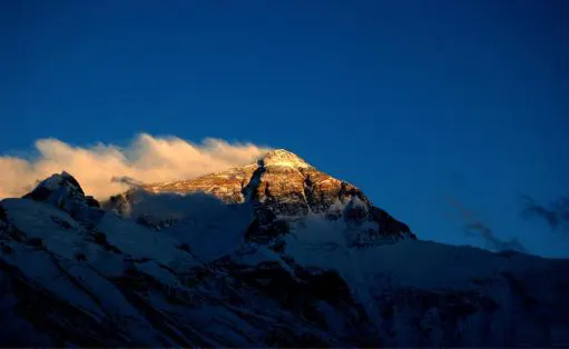 Ten minutes before sunrise the summit lights up while the flanks stay in shadow
