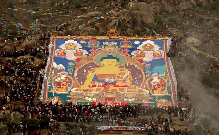 Shoton — the great thangka unrolled down the hillside, the crowd there before dawn