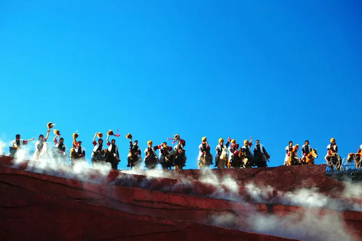 Open-air ethnic performance beneath the peak