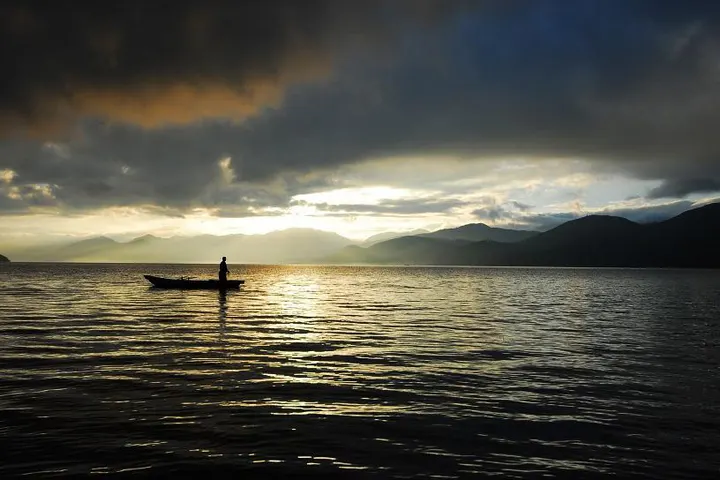 Morning on Lugu Lake, canoes resting on still water