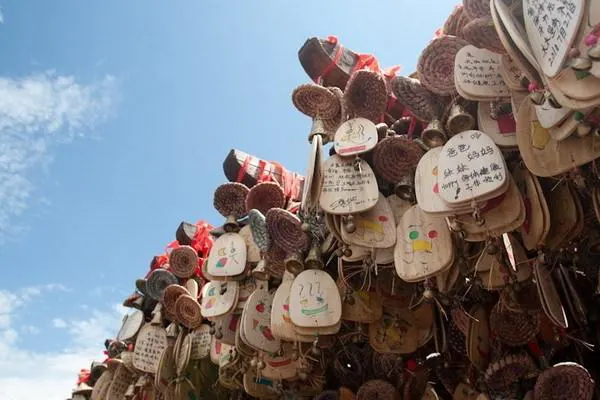 Wooden Dongba wish plaques crowded with hopes