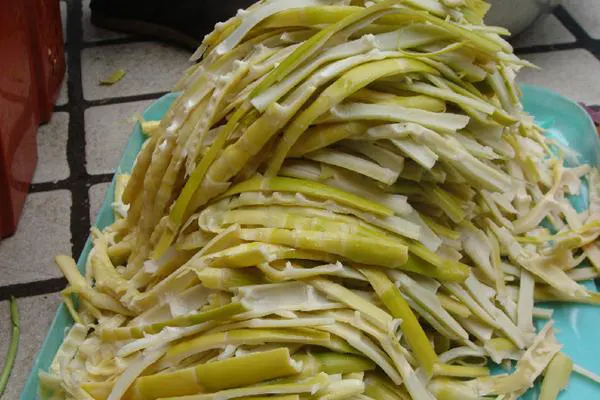 Spring shoots just peeled at the market, sliced into strips and still faintly green