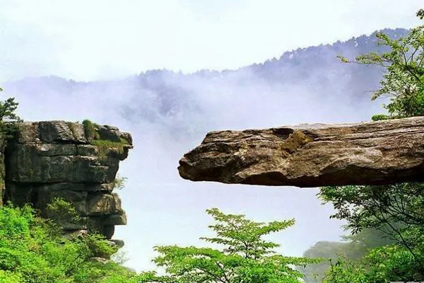 The Heaven Bridge — a slab jutting out over the valley while mist rises underneath
