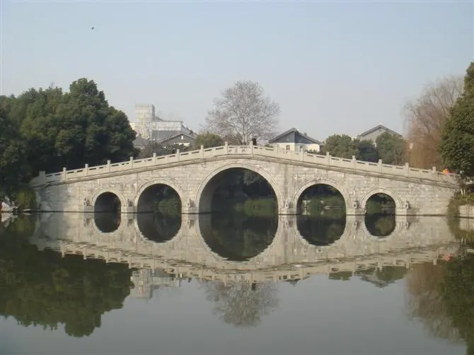 A five-arch stone bridge outside the wall, better in reflection