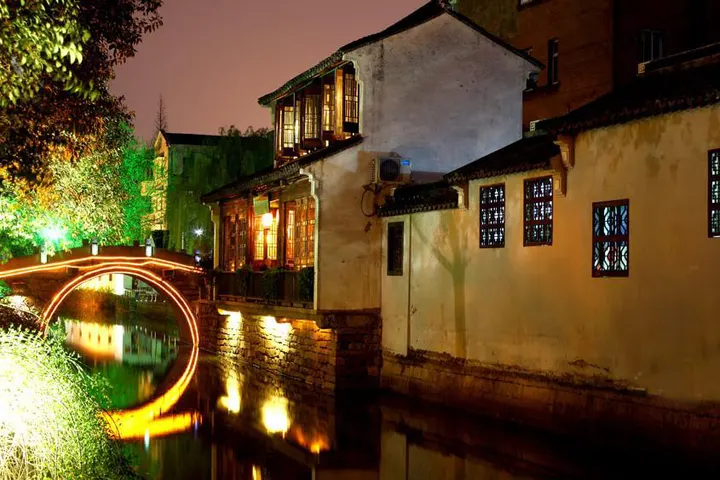 The water lane after nine, lit windows and your own footsteps