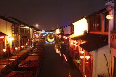Shantang after dark, lanterns strung all the way to the bridge arch