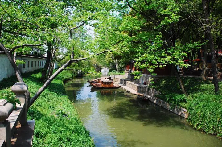 Street and canal side by side, a stone bridge every few dozen metres