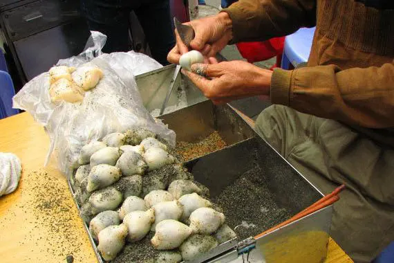 Mochi pounded to order in peanut and sesame sugar