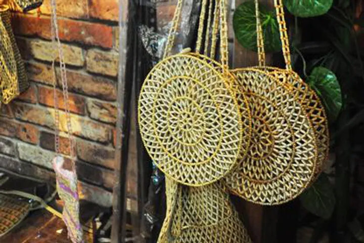 Small woven bamboo baskets hanging on a brick wall