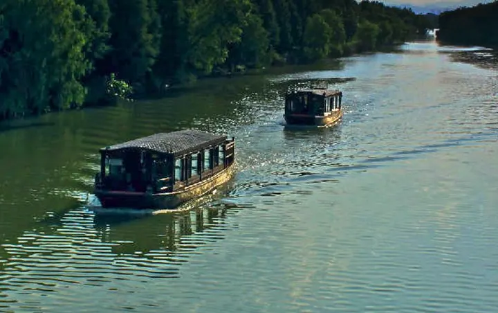 Two electric boats running down the wetland's main channel