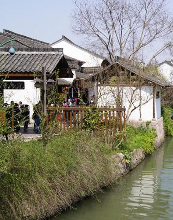 Old houses and a railed terrace above the canal