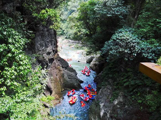 Rafts strung out in the gorge, everyone in orange life jackets