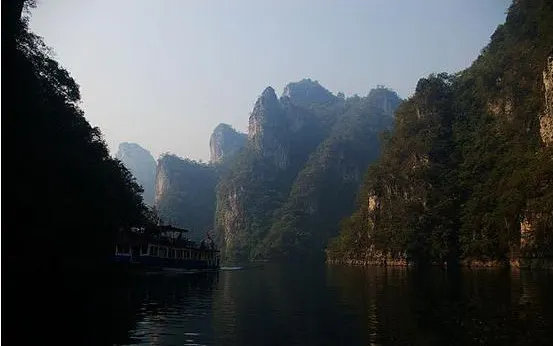 The Wuyang gorge: a tour boat tracking the cliff foot between limestone peaks